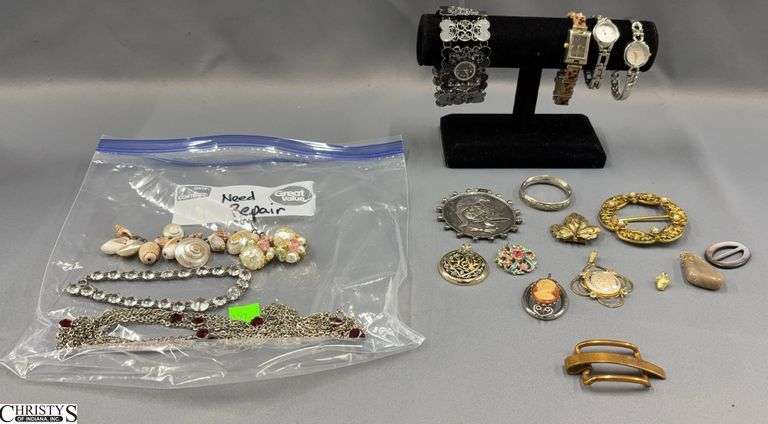 4 Watches, 7 Pendants, a Belt Buckle Marked Solid Bronze Dapper,  Other Small Jewelry Pieces and a Baggie with a Few Pieces of Jewelry That Needs Repair image