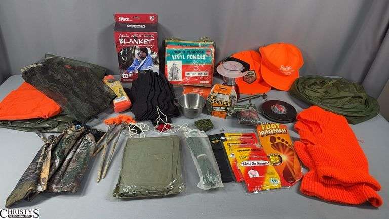 Camping / Hunting Items Including Grabber Outdoors All Weather Blanket in Box, Vinyl Poncho in Package, Orange Hats, Gorilla Tape, Gloves, Remington Net Camo Head Net, 19 Pc. Survival Kit, Deluxe Deer Drag, Foot Warmer, Hand Warmers, Cotton Decoy Anchor Cord and a Bag Marked Hunting Blinds Stuff image