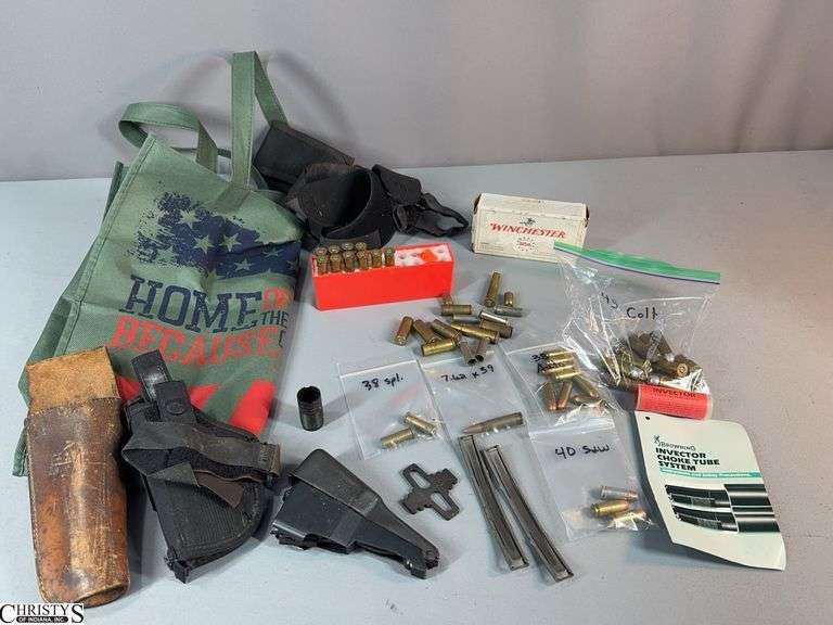 Misc. Ammo, Small Gun Parts and Holsters.  Includes box of 50 cal. 25 Auto Winchester Cartridges, 12 Caliber 45 Colt Cartridges, 3 Caliber 40 S&W Cartridges, 9 Caliber 38 Auto Cartridges, 2 Caliber .38 Special, 1 Caliber 7.62x39 Cartridge, 10 Caliber 30-30 Win Cartridges, Some Brass Pieces, 2 Holsters and a Few Small Gun Parts image