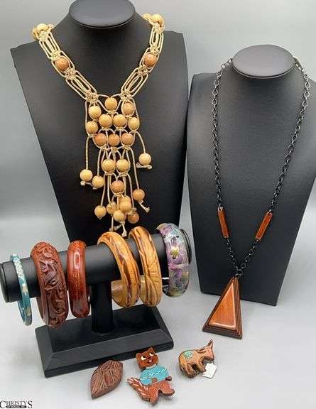 Variety Costume Jewelry, Bangle Bracelets, two necklaces, and a collection of small carved wood figure pins. The necklaces appear to be crafted with wood beads and chain elements image