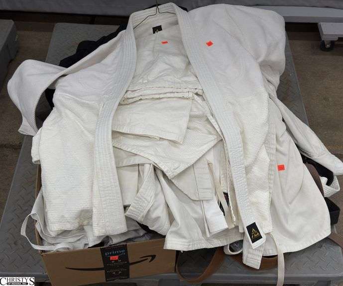 Assorted Karate Gi Jackets, Pants, Belts. Marked Size 5, 4, other. Some wear present, would benefit from a cleaning. SKID NOT INCLUDED. image