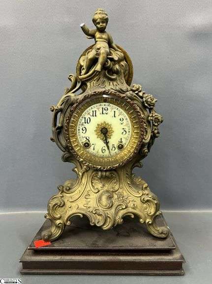 Ansonia Clock Company With Cherub Top Some Damage and Wooden Base" Tall Overall image