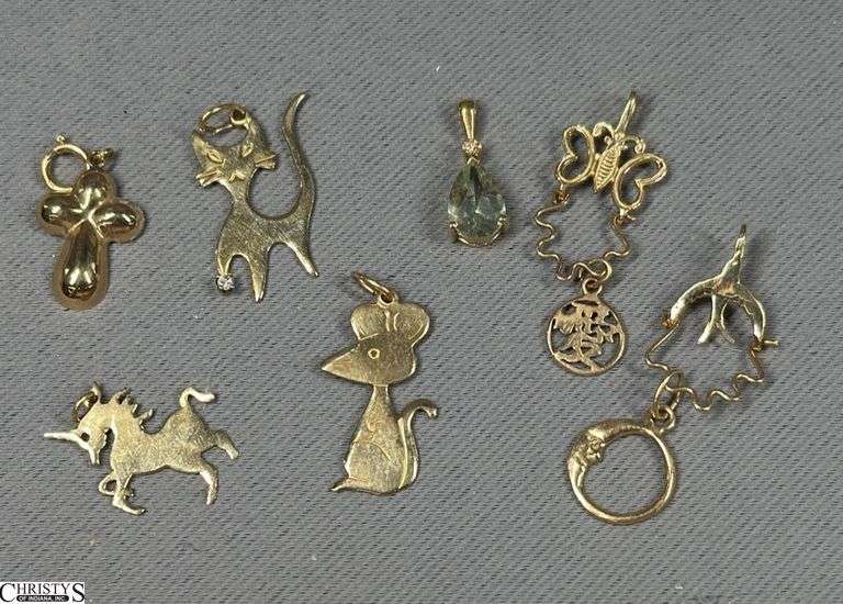 4 14K Charms and 3 14K Pendants.  One Pendant has a Green Amethyst Color Stone and a Tiny Diamond.  The Cat Pendant has a Tiny Diamond too. image