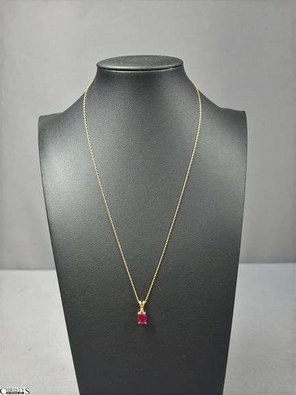 Yellow Gold Chain Marked 14KT.P with an Unmarked Pendant.  Pendant has a Ruby Color Stone and a Small Clear Crystal Stone. image