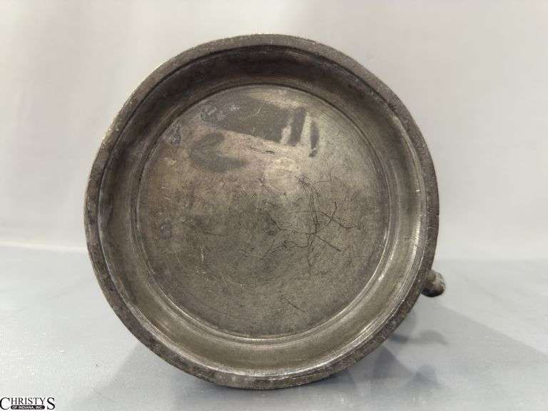 2 Pewter Tankards. Both Marked 'Quart' And Feature A Decorative Handle. One Mug Has GR 329 10 Stamped On It, And The Other Mug Has 1910 Stamped On It.