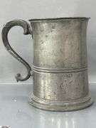 2 Pewter Tankards. Both Marked 'Quart' And Feature A Decorative Handle. One Mug Has GR 329 10 Stamped On It, And The Other Mug Has 1910 Stamped On It.