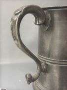 2 Pewter Tankards. Both Marked 'Quart' And Feature A Decorative Handle. One Mug Has GR 329 10 Stamped On It, And The Other Mug Has 1910 Stamped On It.