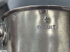 2 Pewter Tankards. Both Marked 'Quart' And Feature A Decorative Handle. One Mug Has GR 329 10 Stamped On It, And The Other Mug Has 1910 Stamped On It.