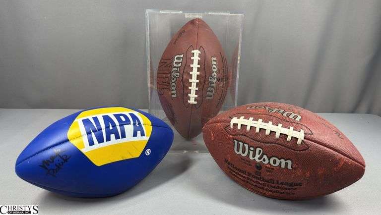 3 Footballs- One Blue NAPA Auto Parts and 2 Wilson National Football League.  One Wilson has autographed but they are fading and can not be read.  The other Wilson ball is in a display case. image