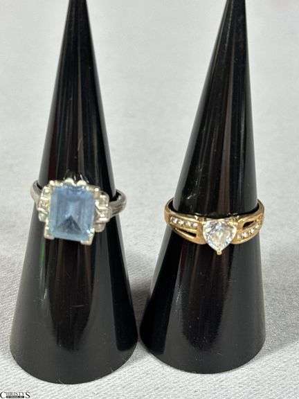 Two 10K Rings.  One with a light blue center stone and one with a clear heart shaped stone. image