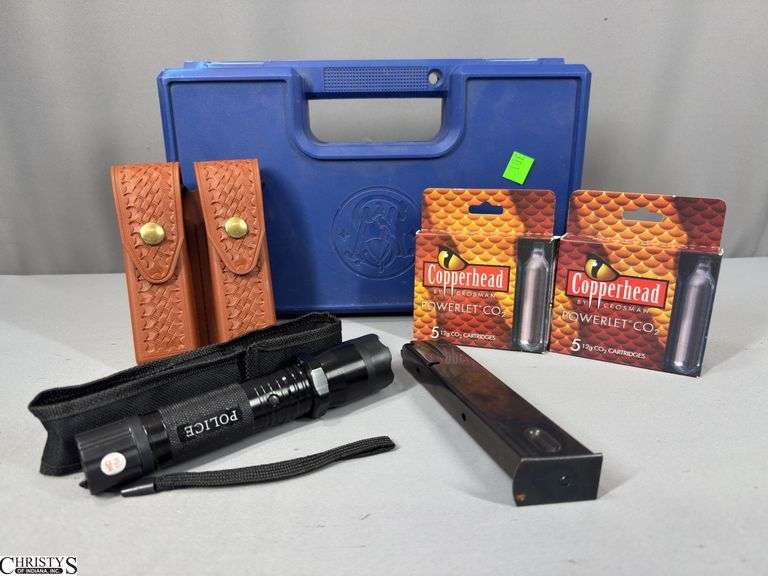3 9mm Magazines and a HKS Double Stack Magazine Carrier, XL Personal Protection Stun Gun & Flashlight Combo  (There is NO Charging Cord),  8 Copperhead by Crosman Powerlet CO2 Cartridges, and a Blue S&W Empty Gun Case. image