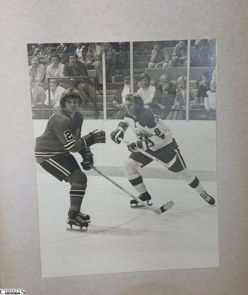 2 Mid-1970's Original Racers Hockey Photos Mounted on Cardboard and "Slap Shot" Memorabilia.  Includes a Hanson Brothers Autographed Photo, Autographed DVD Cover,  Sports Illustrated Slap Shot Autographed Magazine, "Slap Shot" The Book by Richard Woodley Autographed.