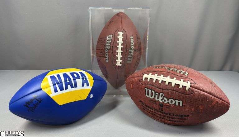 3 Footballs- One Blue NAPA Auto Parts and 2 Wilson National Football League.  One Wilson has autographed but they are fading and can not be read.  The other Wilson ball is in a display case.
