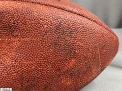 3 Footballs- One Blue NAPA Auto Parts and 2 Wilson National Football League.  One Wilson has autographed but they are fading and can not be read.  The other Wilson ball is in a display case.