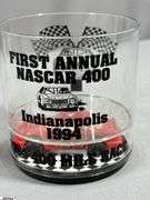 Racing Memorabilia.  Large Legends of Indy Poster, 2 Auto Racing Digest Nov. 1983 and July 1974, Two "First Annual Nascar 400 Indianapolis 1944" Plastic Commemorative Cups, 2 Goodyear Nascar Posters and a 2014 500 Festival Pin
