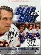 2 Mid-1970's Original Racers Hockey Photos Mounted on Cardboard and "Slap Shot" Memorabilia.  Includes a Hanson Brothers Autographed Photo, Autographed DVD Cover,  Sports Illustrated Slap Shot Autographed Magazine, "Slap Shot" The Book by Richard Woodley Autographed.