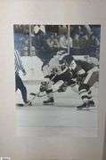 2 Mid-1970's Original Racers Hockey Photos Mounted on Cardboard and "Slap Shot" Memorabilia.  Includes a Hanson Brothers Autographed Photo, Autographed DVD Cover,  Sports Illustrated Slap Shot Autographed Magazine, "Slap Shot" The Book by Richard Woodley Autographed.