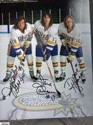 2 Mid-1970's Original Racers Hockey Photos Mounted on Cardboard and "Slap Shot" Memorabilia.  Includes a Hanson Brothers Autographed Photo, Autographed DVD Cover,  Sports Illustrated Slap Shot Autographed Magazine, "Slap Shot" The Book by Richard Woodley Autographed.