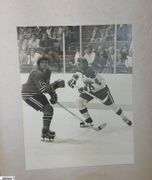 2 Mid-1970's Original Racers Hockey Photos Mounted on Cardboard and "Slap Shot" Memorabilia.  Includes a Hanson Brothers Autographed Photo, Autographed DVD Cover,  Sports Illustrated Slap Shot Autographed Magazine, "Slap Shot" The Book by Richard Woodley Autographed.