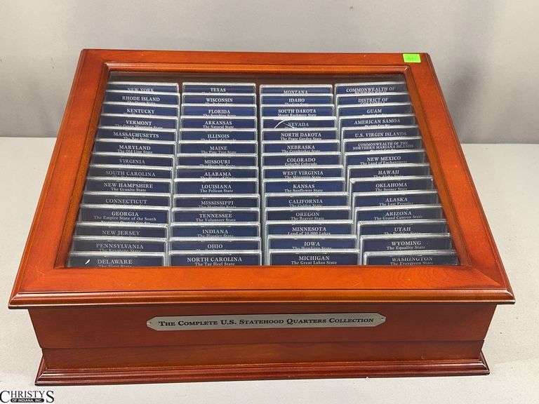 The Complete U.S. Statehood Quarters 56 Piece Collection Set in Display Box with Glass Top.  Set includes 56 3-Piece Statehood Quarter Coin Sets.  Nevada set has a cracked package.  See Photo.  17 1/2" X 15" X 7" image