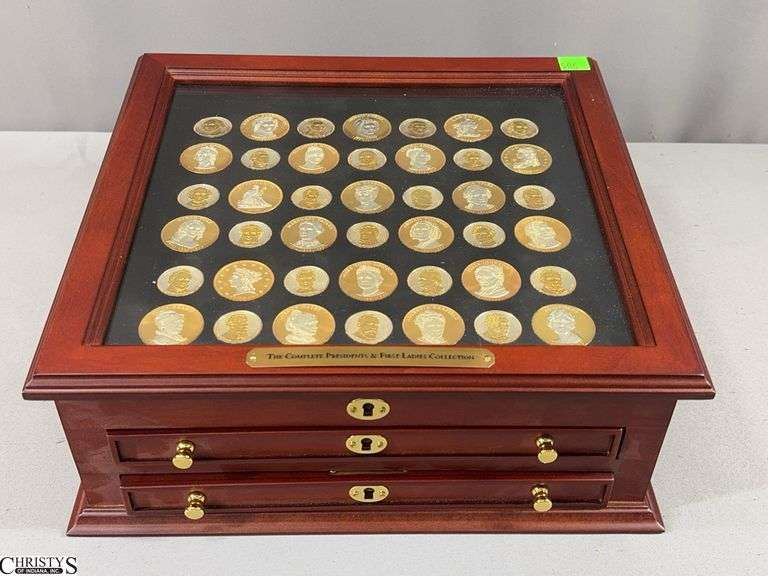 Presidents and First Ladies Collection in Glass Top Display Box with Cardboard Information Cards About Each President and First Lady.  Each pieces is gold and silver in color and coated with a plastic covering.  Presidential pieces marked $1. image