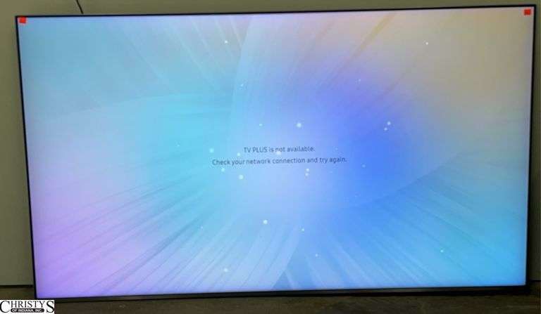 Samsung 2018 65" TV and Remote - Lower left corner of trim appears cracked image