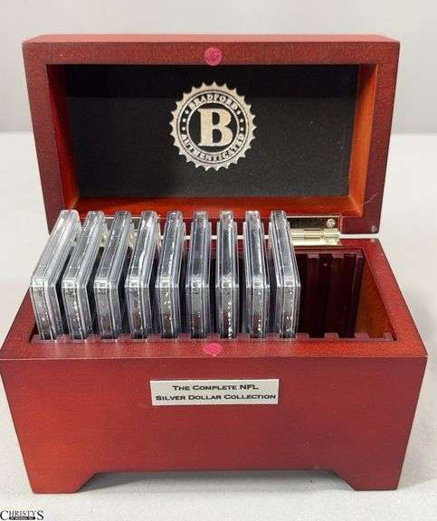 9 Piece NFL Silver Dollar Collection in Wooden Box.  Contains 9 2015 NFL BU Silver Dollars with Each Team's Logo in Official Team Color Plus It's Name and Year Established.  Includes Patriots, Dolphins, Chiefs, Washington Football Team, Cardinals, Buccaneers, Cleveland Browns, Carolina Panthers and Texans image