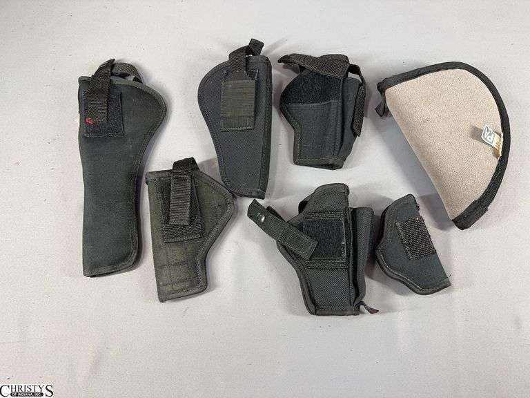 6 Black Nylon Handgun Holsters in Various Sizes and a Small Grey Handgun Pouch image