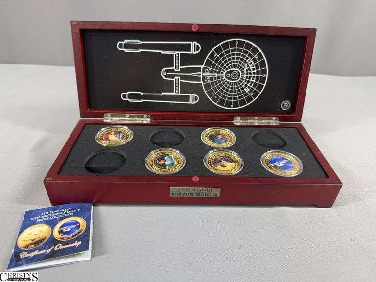 U.S.S. Enterprise Gold Proof Collection in Wood Display Box.  Incudes 5 Star Trek 50th Anniversary Legacy Proof Rounds with Certificate of Authenticity.  Each piece plated in 24K gold. image