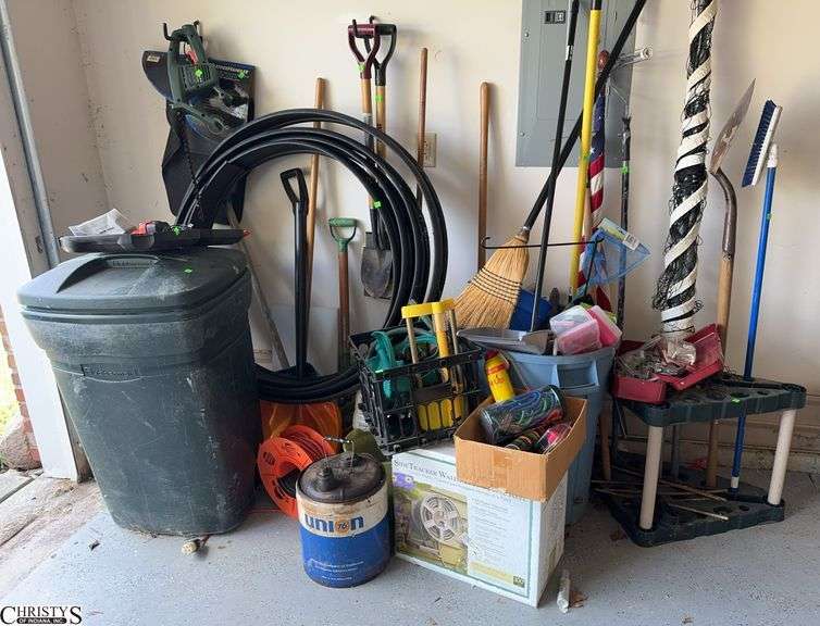 Garage Lot. Shovels Rakes Extension Cord Drill Lawn Tools Chemicals Flag image