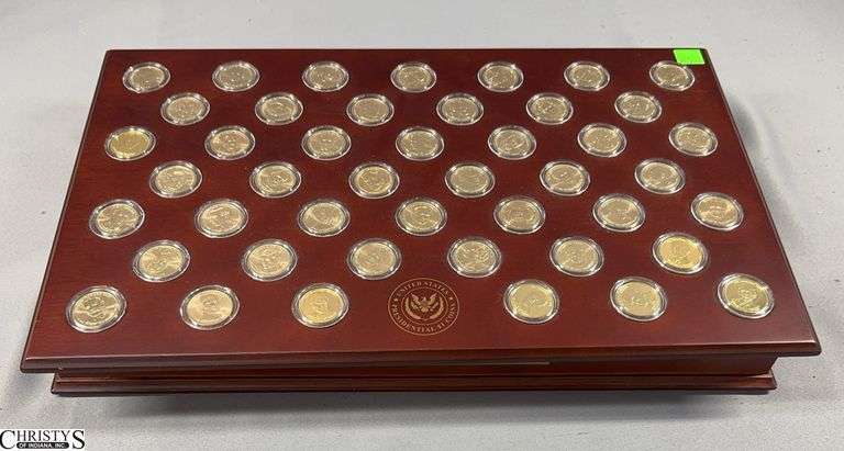 United States Presidential Dollars Set in Wooden Display Box.  The set includes 45 Individual Presidential Dollars and 40 Uncirculated Rolls of 12 Coins Sealed in Tube by the Danbury Mint.  A Total of 524 Presidential Dollars. image