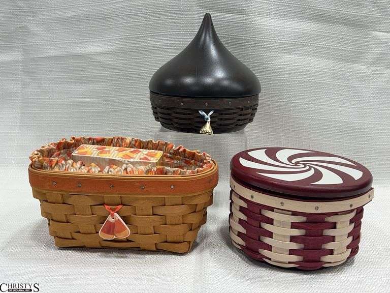 3 Small Longaberger Baskets- 2009 Tree Trimming Peppermint Twist with Lid, Protector and Liner, 1999 Candy Corn Basket with Liner and Protector, and a Hershey Kiss Sweetheart Basket with Lid and Liner image