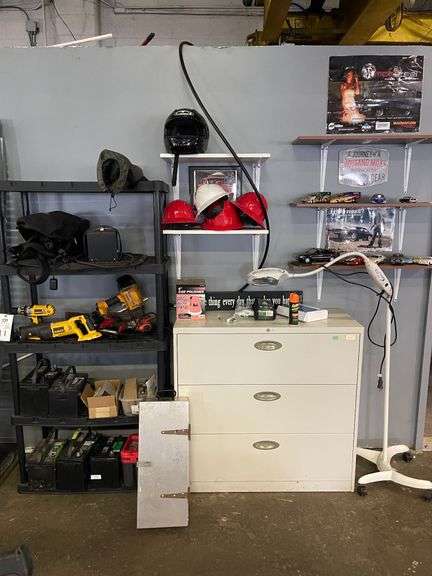 Shelving Unit with Tools, File Cabinet with Contents, Helmets, Light, Toy Cars image