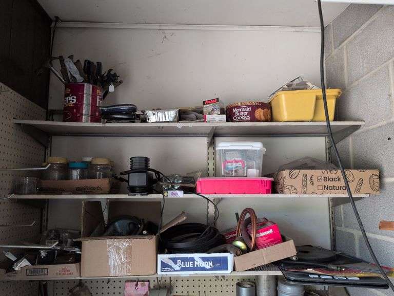 3 shelves: car mats, various hand tools, oil filters, 12v air compressor and misc. image