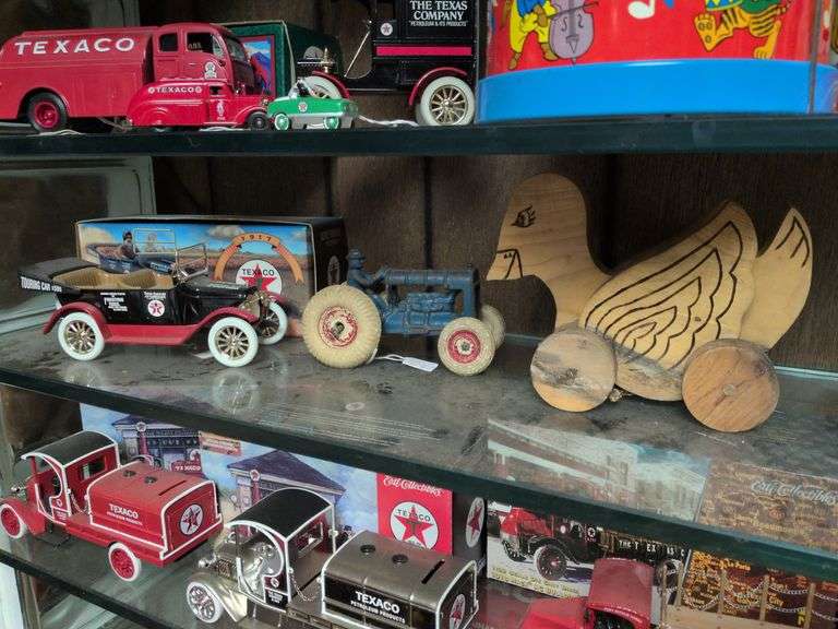 Ertl Texaco car bank with box, Arcade cast iron tractor with rubber tires and a wooden pull toy duck image