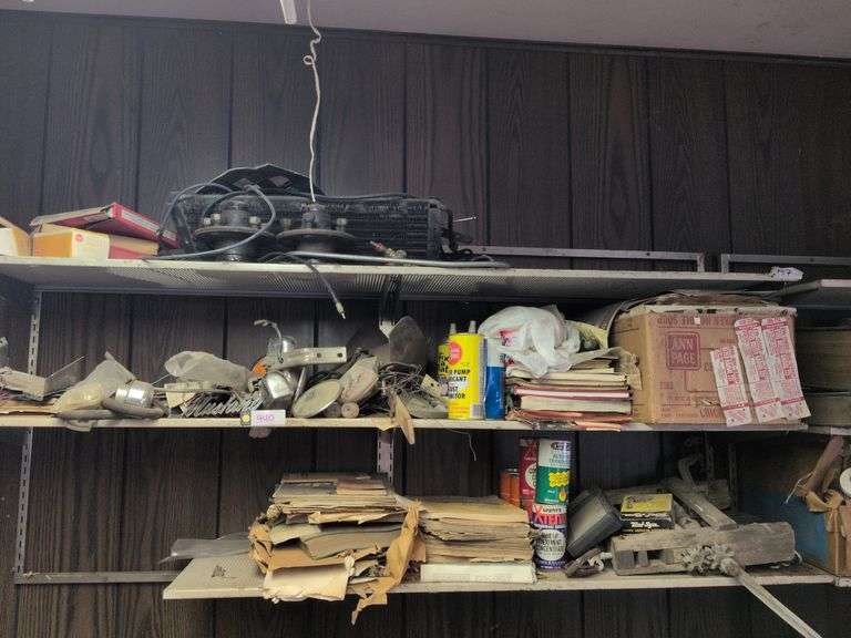 4 shelves: wheel hubs, Auto manuals, shop fluids, car parts and misc. image