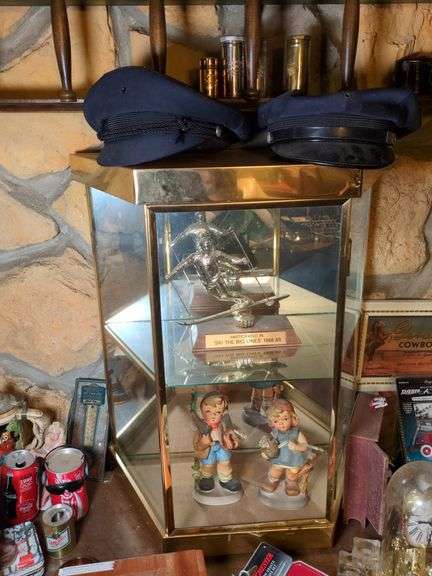Glass case, Dick Tracy camera, Colgate shaving cream canisters, ceramic children figurines , ski trophy, 2 hats and misc. image