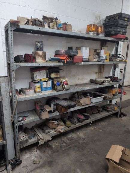 Metal rack and contents: emergency lights, empty tool boxes and misc. image