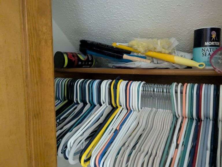 Items in closet: shoe rack, Ozark trail rapids rider III, hangers tennis balls and misc.