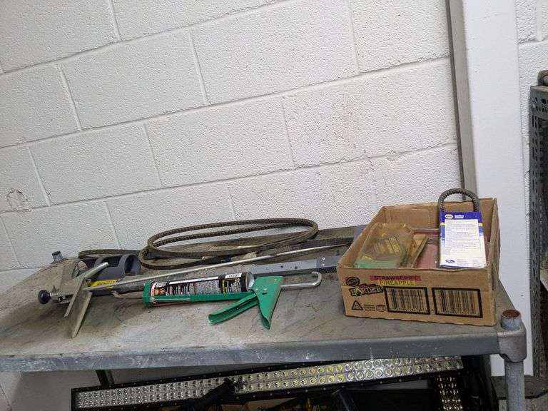 Shelf and contents of top shelf: caulking gun and misc.