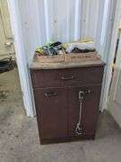 Cabinet (24"x  20"x 37") and contents with tape, safety glasses, rain suits and misc.