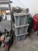 Three gray tubs with security system