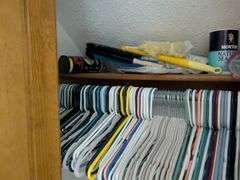 Items in closet: shoe rack, Ozark trail rapids rider III, hangers tennis balls and misc.