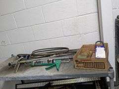 Shelf and contents of top shelf: caulking gun and misc.