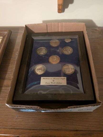 Milestones and Man Flight coins by Trans World Airlines and misc. international coins on wood image