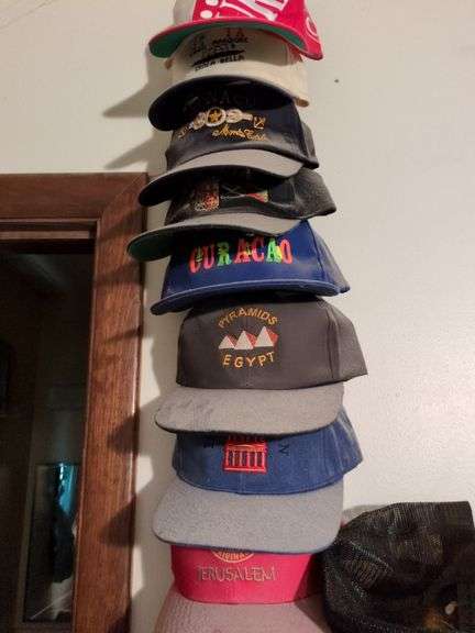 Box of hats including hats from overseas and hat stand