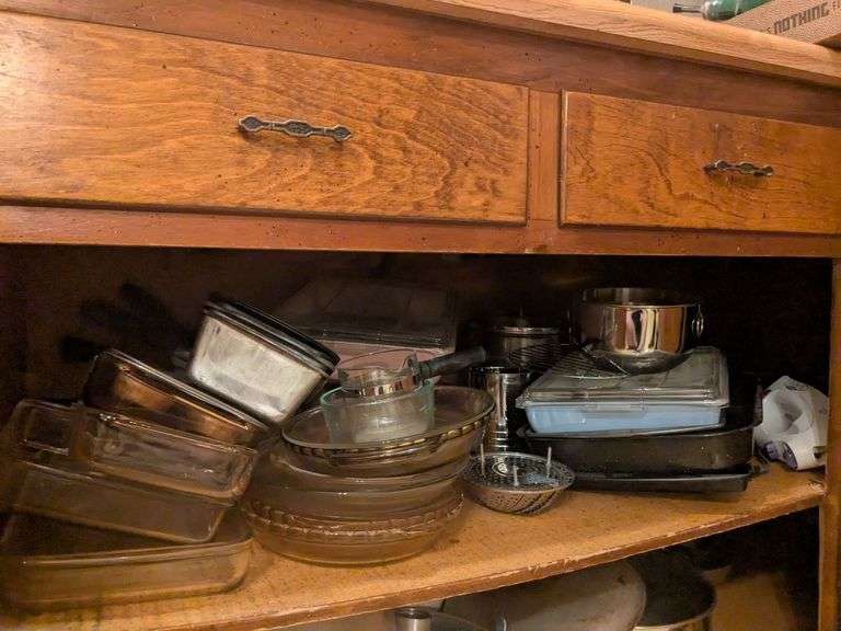 Top shelf: pie plates, baking dishes, sifter, bowls and misc. image