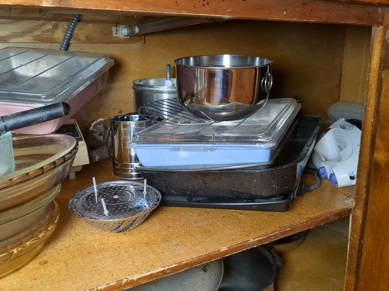 Top shelf: pie plates, baking dishes, sifter, bowls and misc.