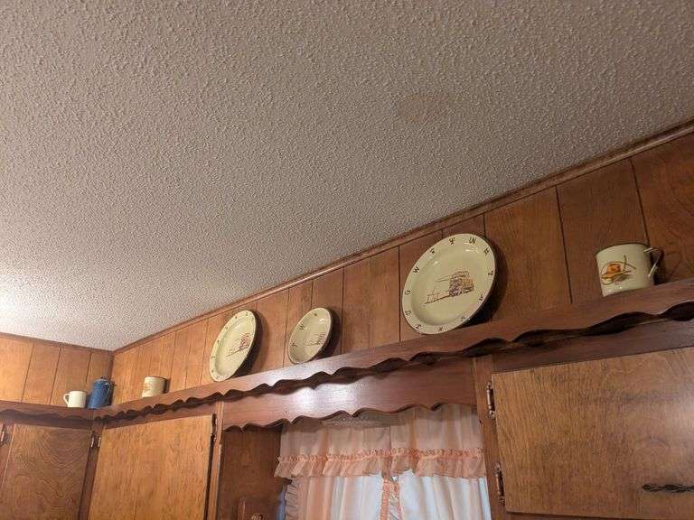 Decorative dishes and tins on top ledge image