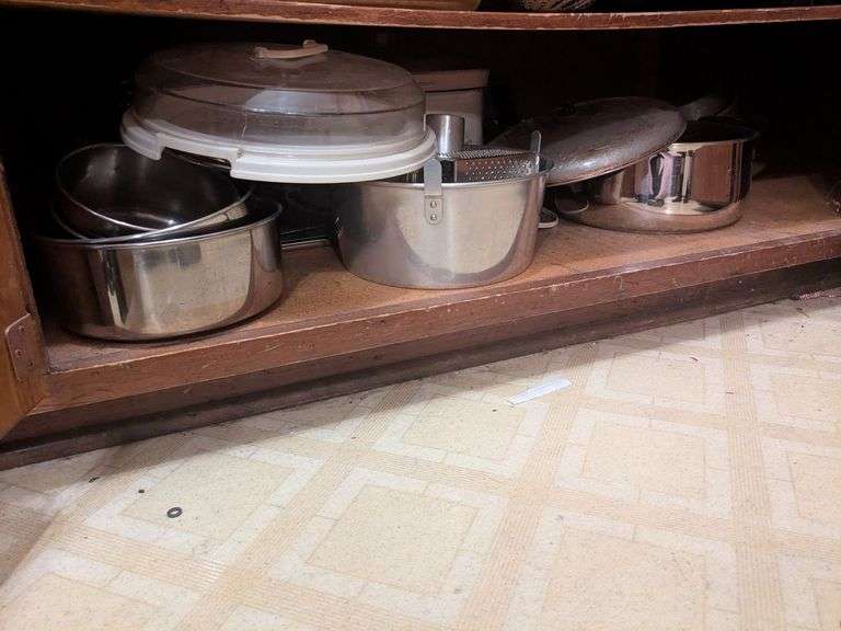 Bottom shelf and bottom drawer: pots, pans, lids, pie holder and misc. image
